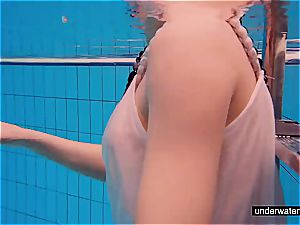 redhead honey swimming naked in the pool